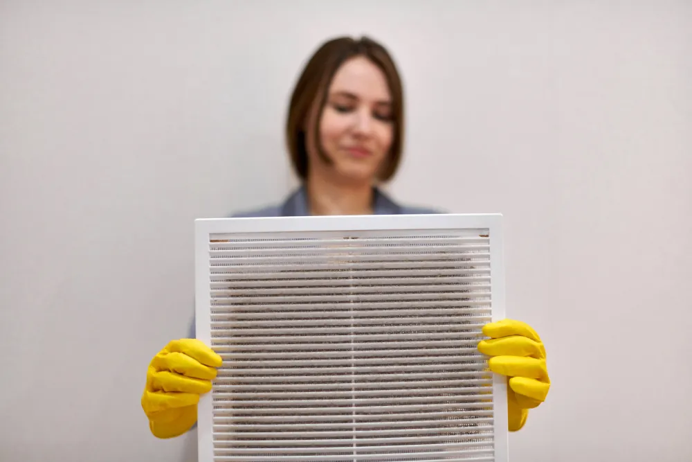 Indoor air quality services in Hermiston, OR - Woman holding up a dirty air filter