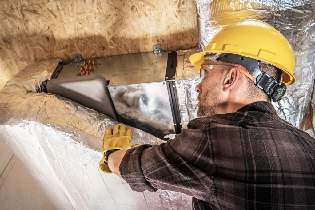 Hvac worker performing duct cleaning